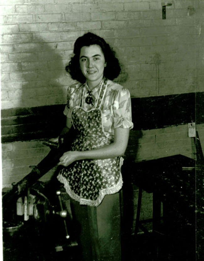 Woman with apron, floral blouse, pendant