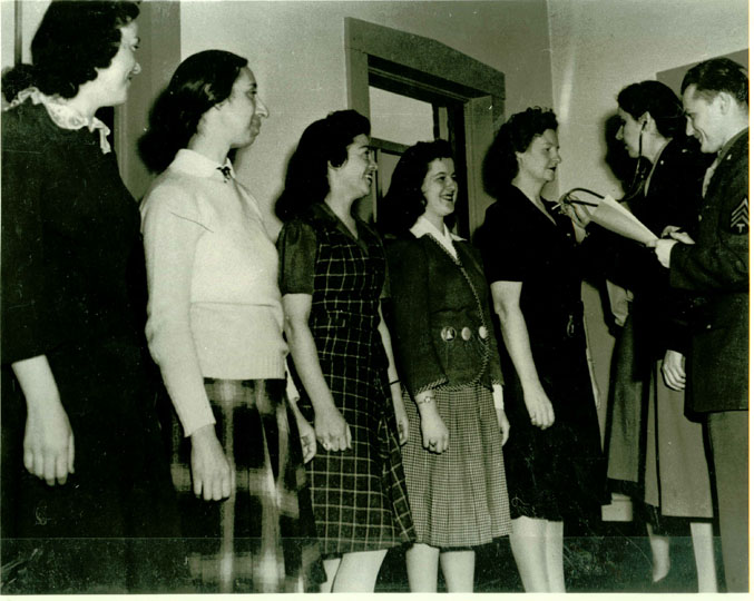 These women line up for medical inspection from Dr. Hazel Richards